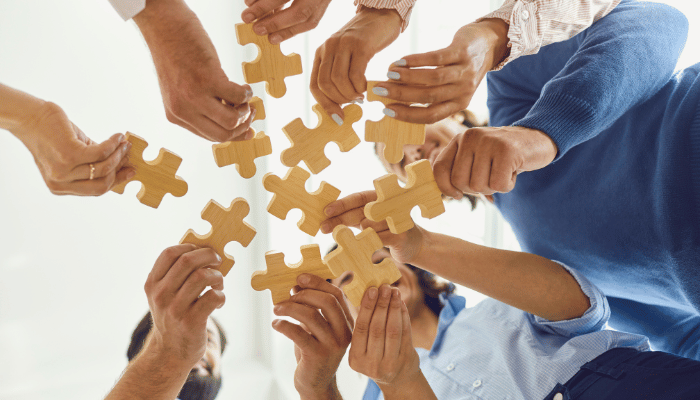 Business strategy puzzle pieces fitting together
